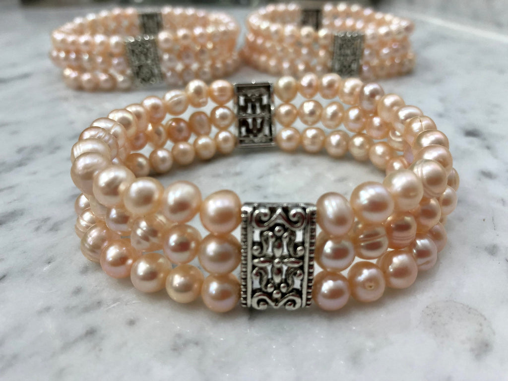 Salmon Colored Freshwater Pearl Stretch Bracelet with Metal Amulets