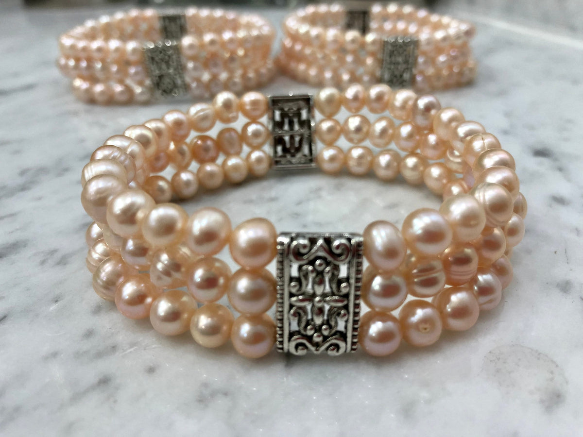 Salmon Colored Freshwater Pearl Stretch Bracelet with Metal Amulets