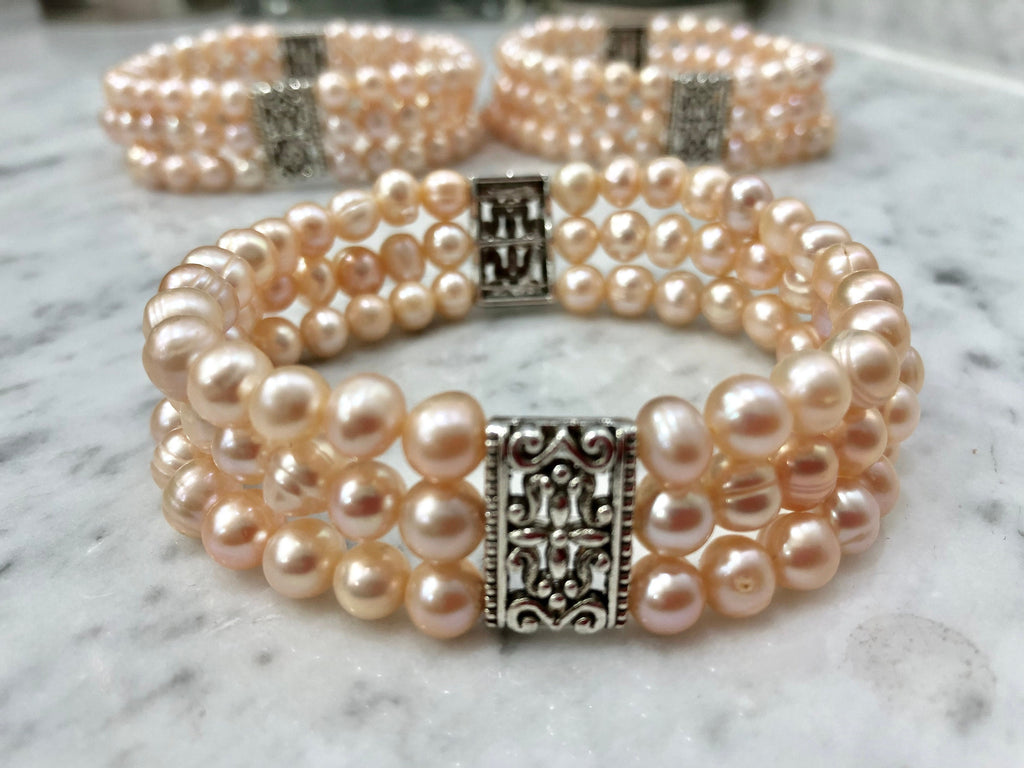 Salmon Colored Freshwater Pearl Stretch Bracelet with Metal Amulets