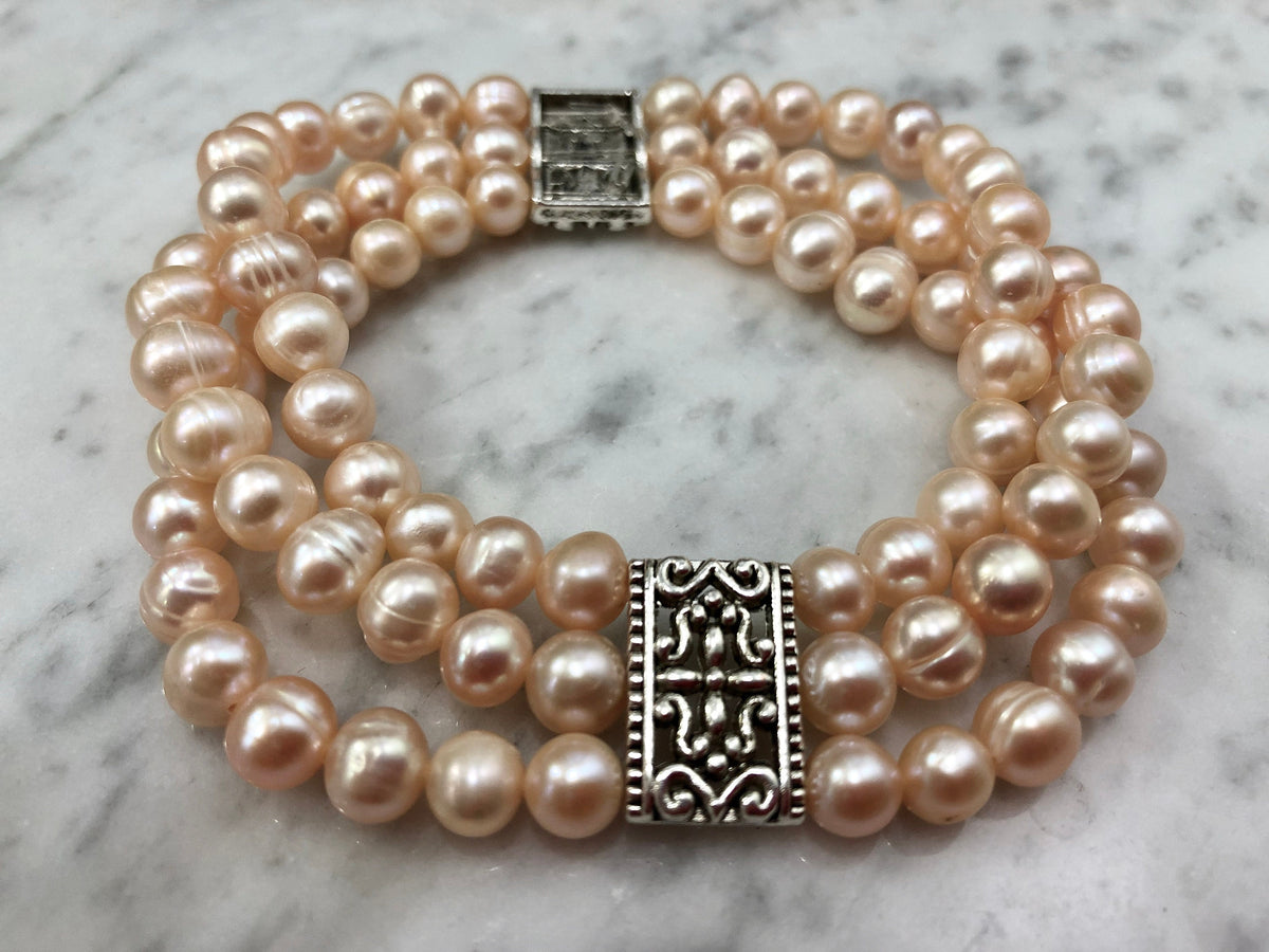 Salmon Colored Freshwater Pearl Stretch Bracelet with Metal Amulets