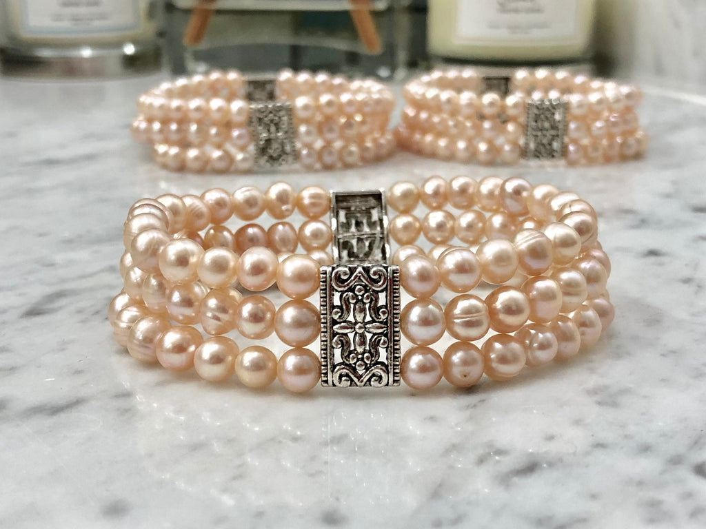 Salmon Colored Freshwater Pearl Stretch Bracelet with Metal Amulets