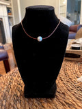 Floating White Pearl on Brown Leather