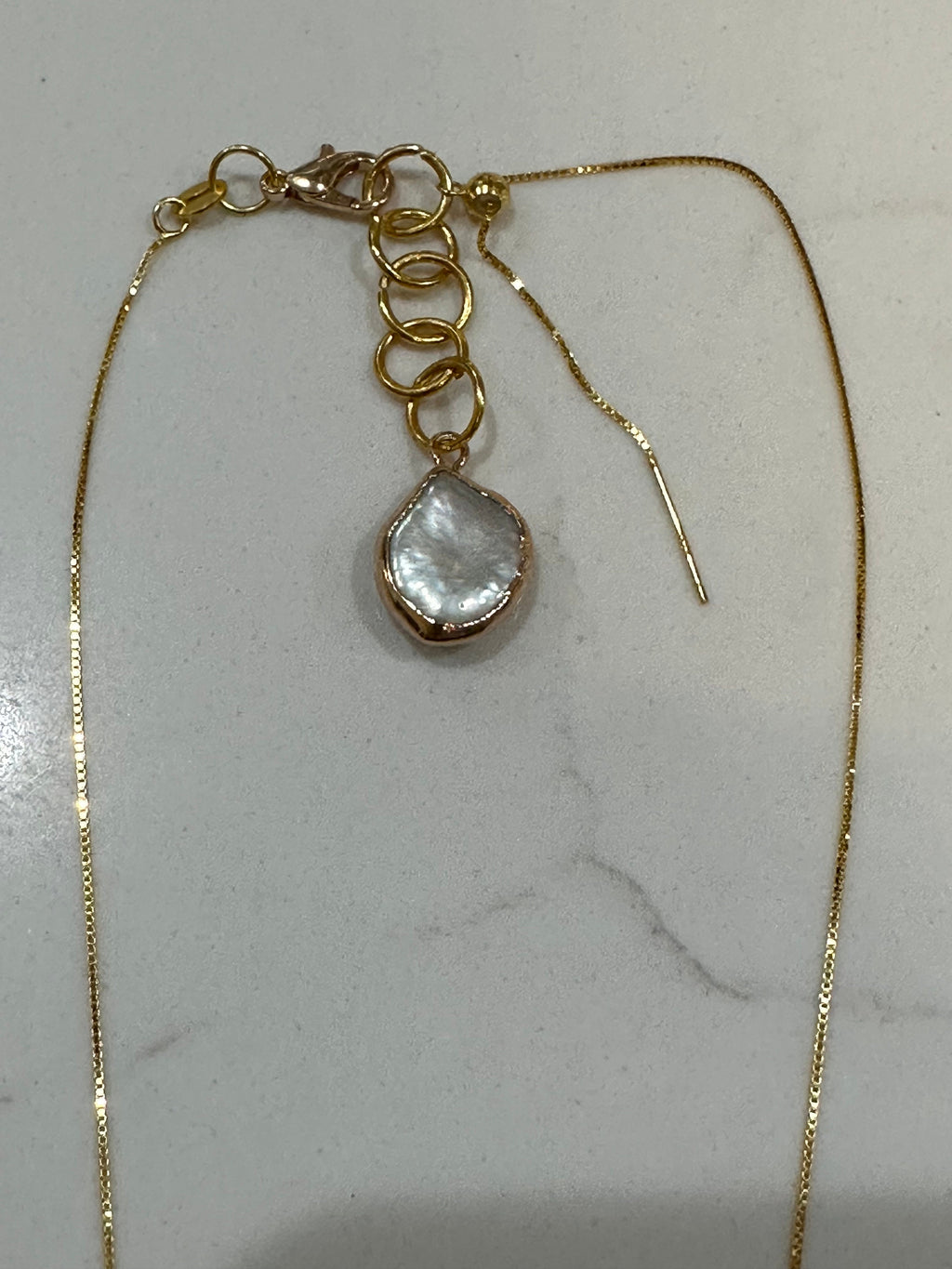 For an additional 10.00, you will get an upgraded lobster clasp and a handmade 14k coin pearl extension pictured here.