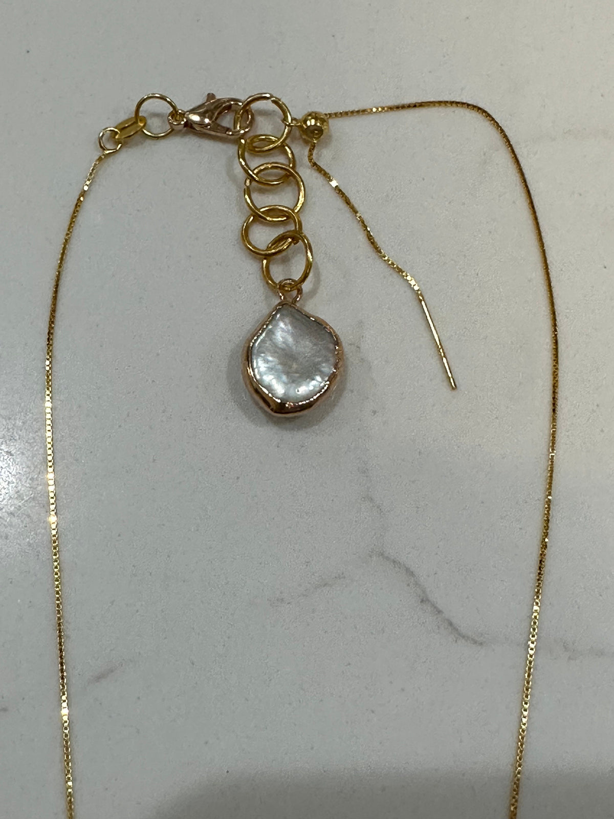 For an additional 10.00, you will get an upgraded lobster clasp and a handmade 14k coin pearl extension pictured here.