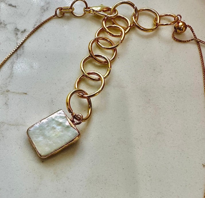 This is an extender that is handmade and is an additional 10.00.It includes a pearl coated in 14k gold electroplated. Be sure to choose this in variations.I can make them in yellow gold color, rose gold color and silver.
